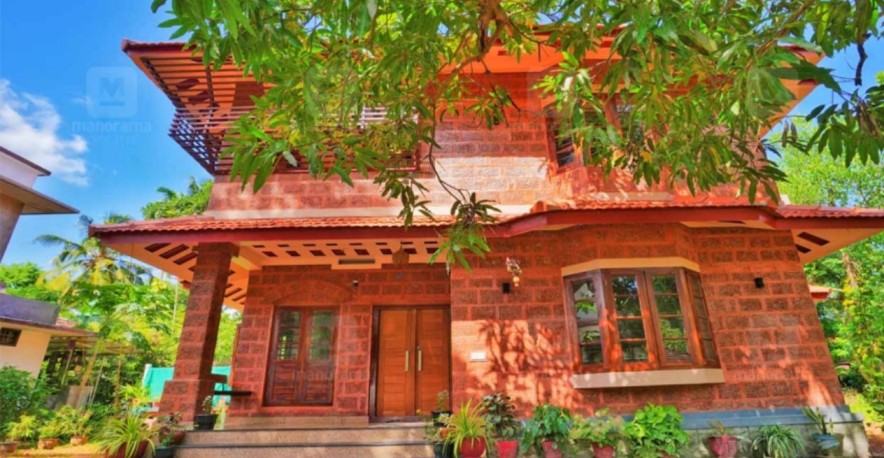 the eco friendly house of mini in thrissur made of red stone and mud