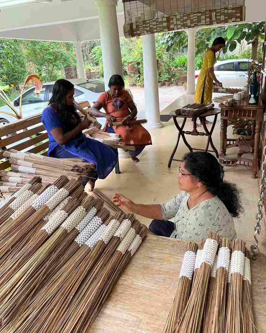 The broomsticks are stitched and trimmed by a set of women