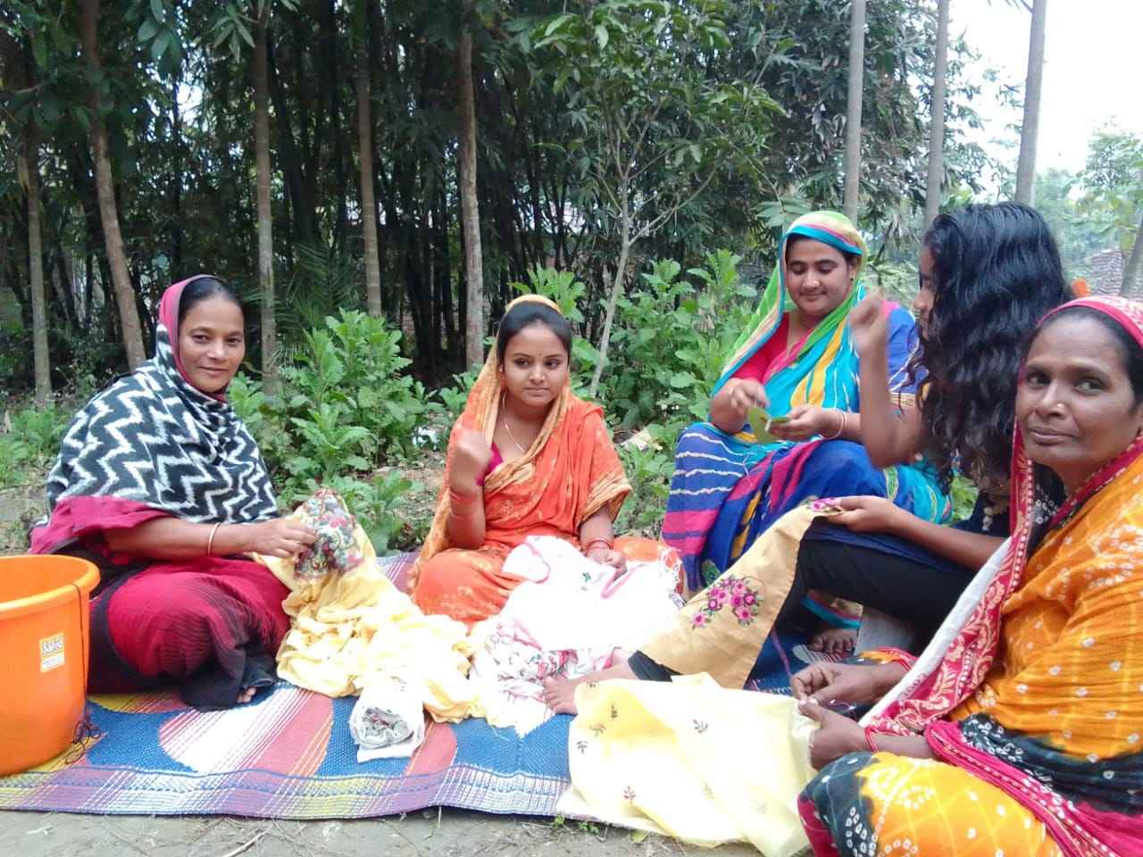 The women stitching clothes for children at Khudey