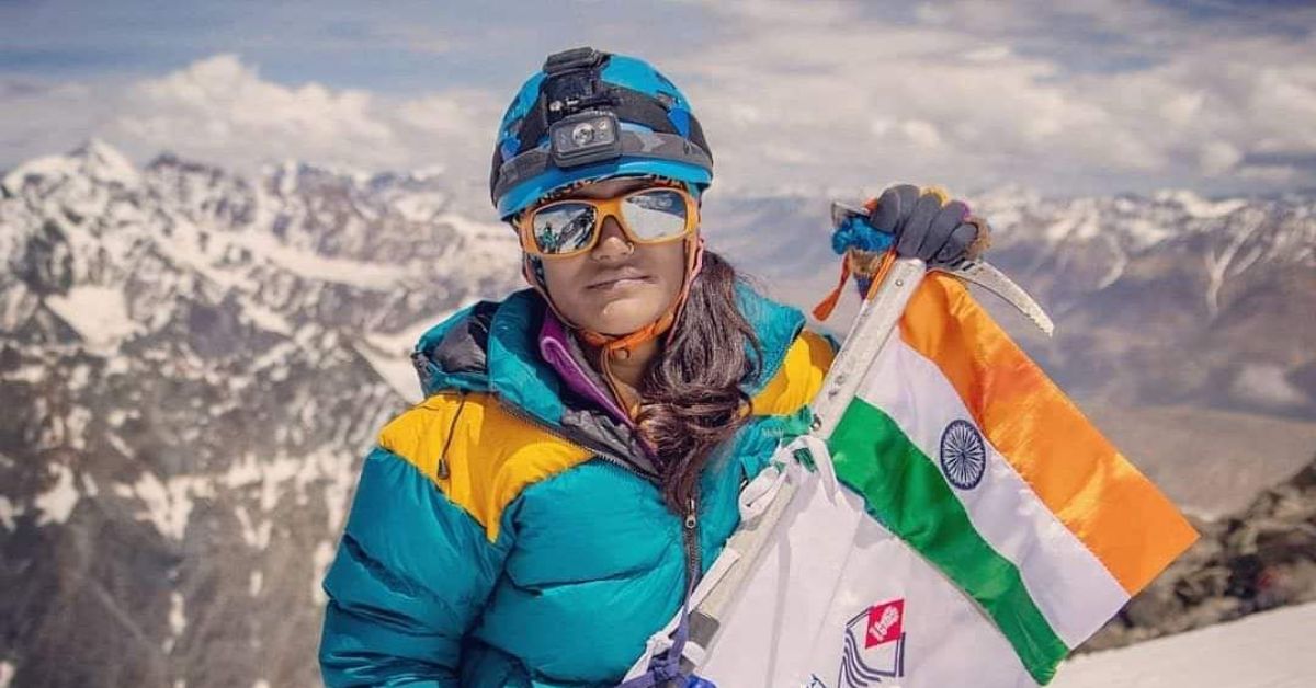 uttarakhand mountaineer savita kanswal holds an indian flag as she stands atop a mountain after an expedition