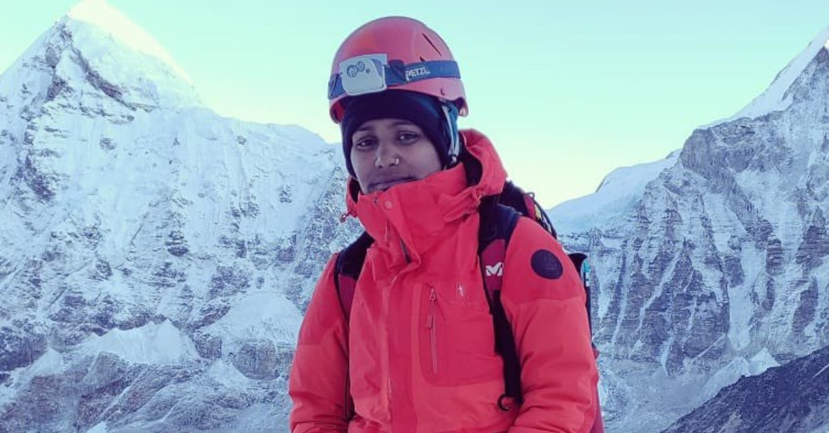 uttarakhand mountaineer savita kanswal stands atop a mountain after an expedition