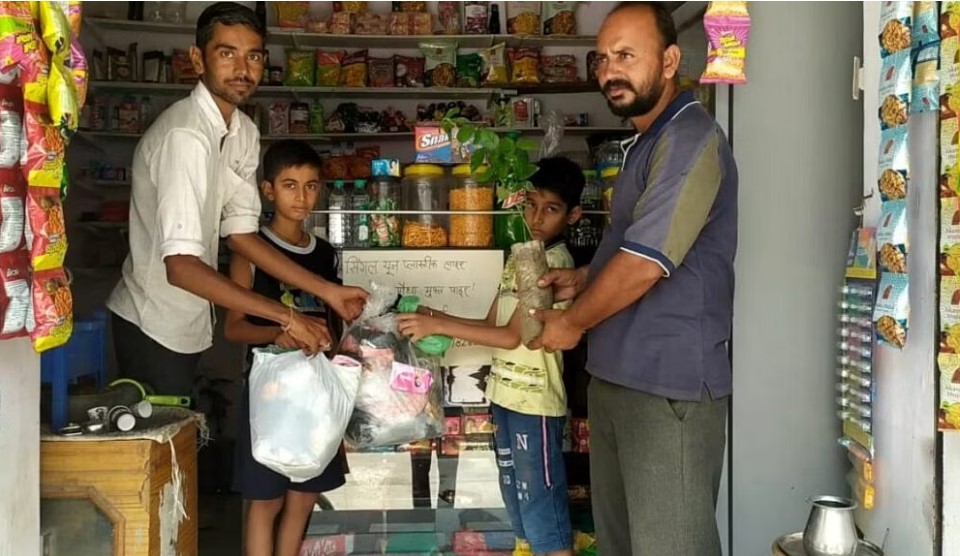 Kana Ram collecting waste from his customers.