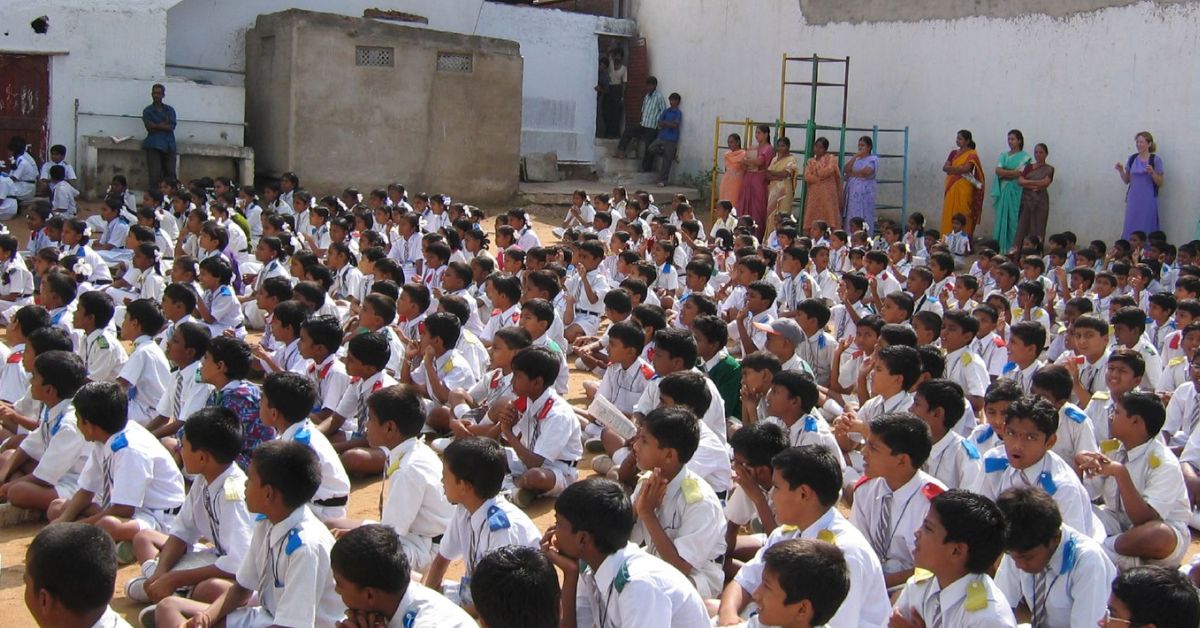 school children sitting on the floor 