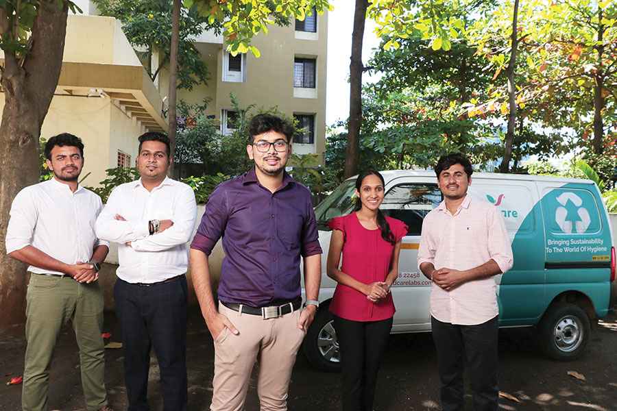 Ajinkya with his team of Pad Care labs behind the sanitary disposal system