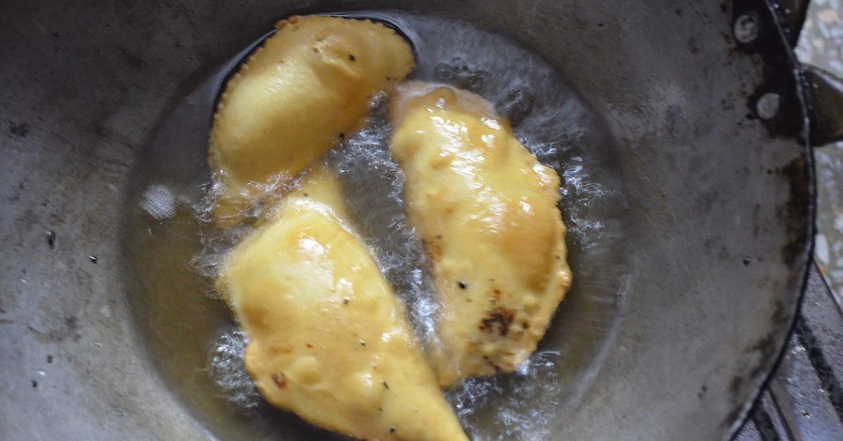 Gujiyas are deep-fried for five to six minutes till they turn golden brown.