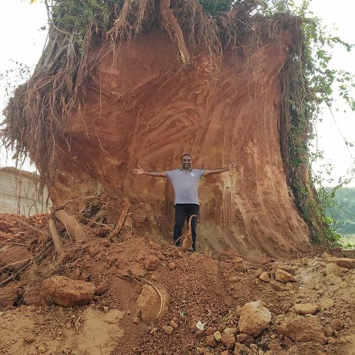 Jeeth Milan Roche, an environmentalist in Karnataka, stands by a huge tree.