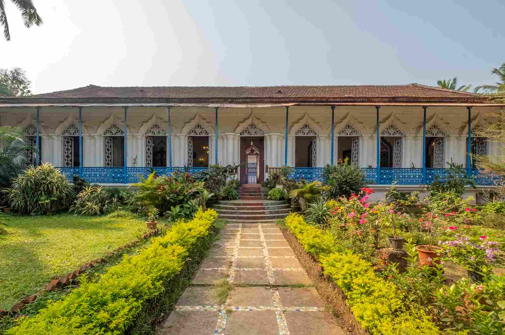The Antao House in Goa is a beautiful property with lush gardens and a colourful facade