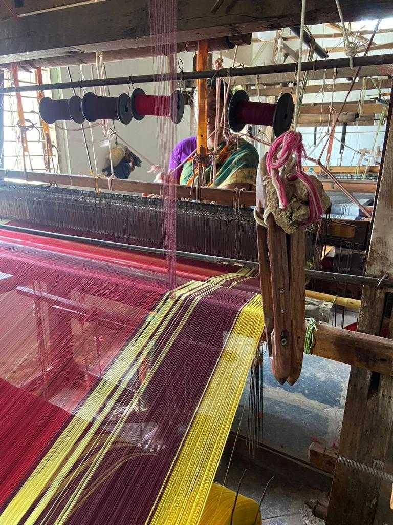 The weaving process is intricate and takes days to complete a single saree