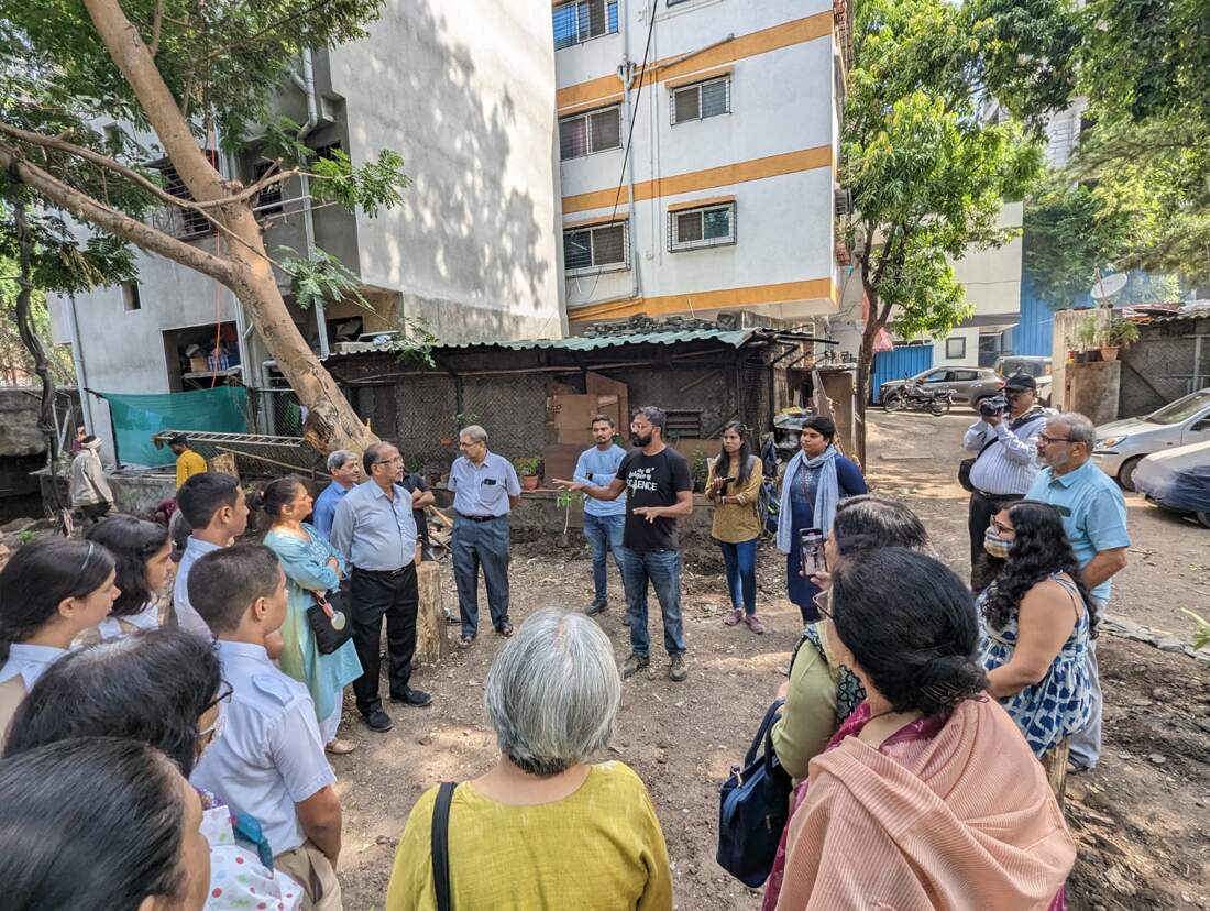 Dr Prasanna Jogdeo (in a black T-shirt) speaking to an audience about his startup's work.