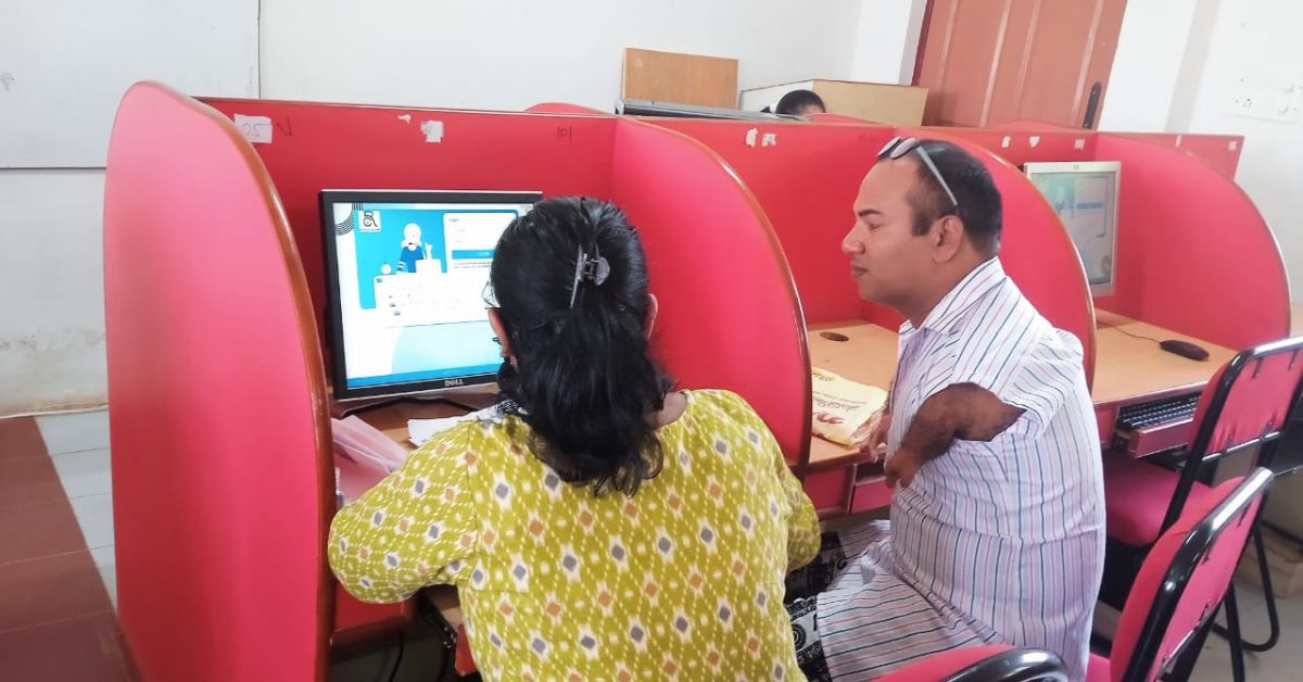 Pushpa writing an exam for a person with a physical disability.