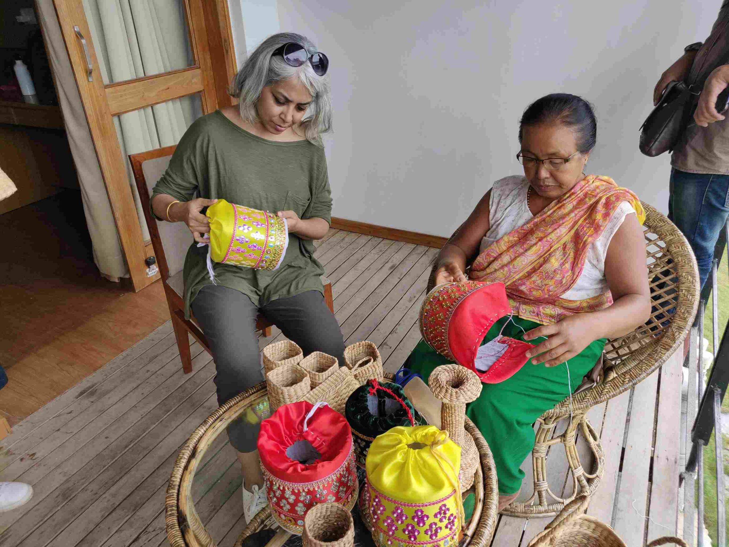 Julie (L) with one of the local women during an embroidery workshop organised by Curtain Call Adventures