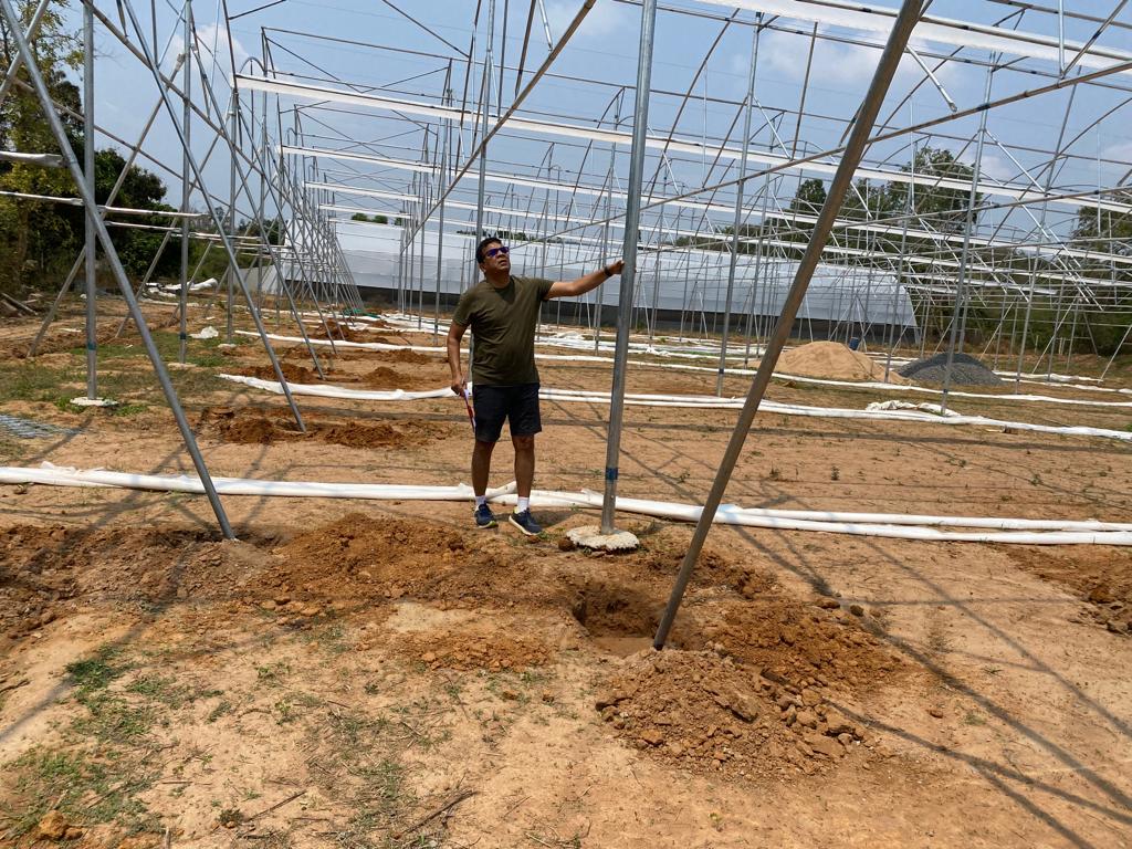Colonel Mohanty inspecting the new polyhouse being set up on his farm.