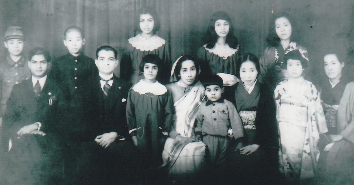 Asha (second from the right in the last row) with her family and neighbours in Japan.