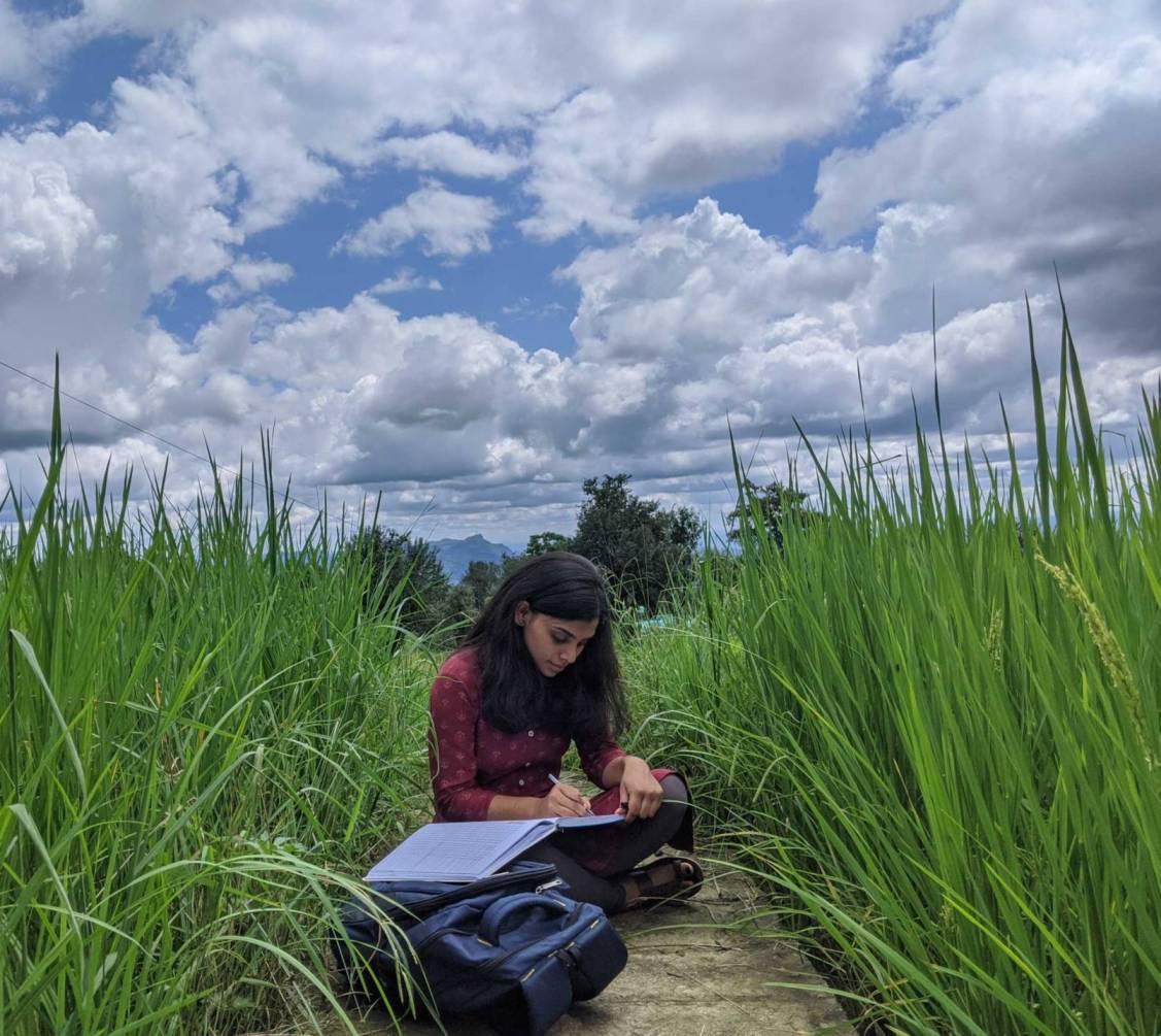Babli is engrossed in journaling her thoughts on a beautiful sunny day in a village in Himachal.
