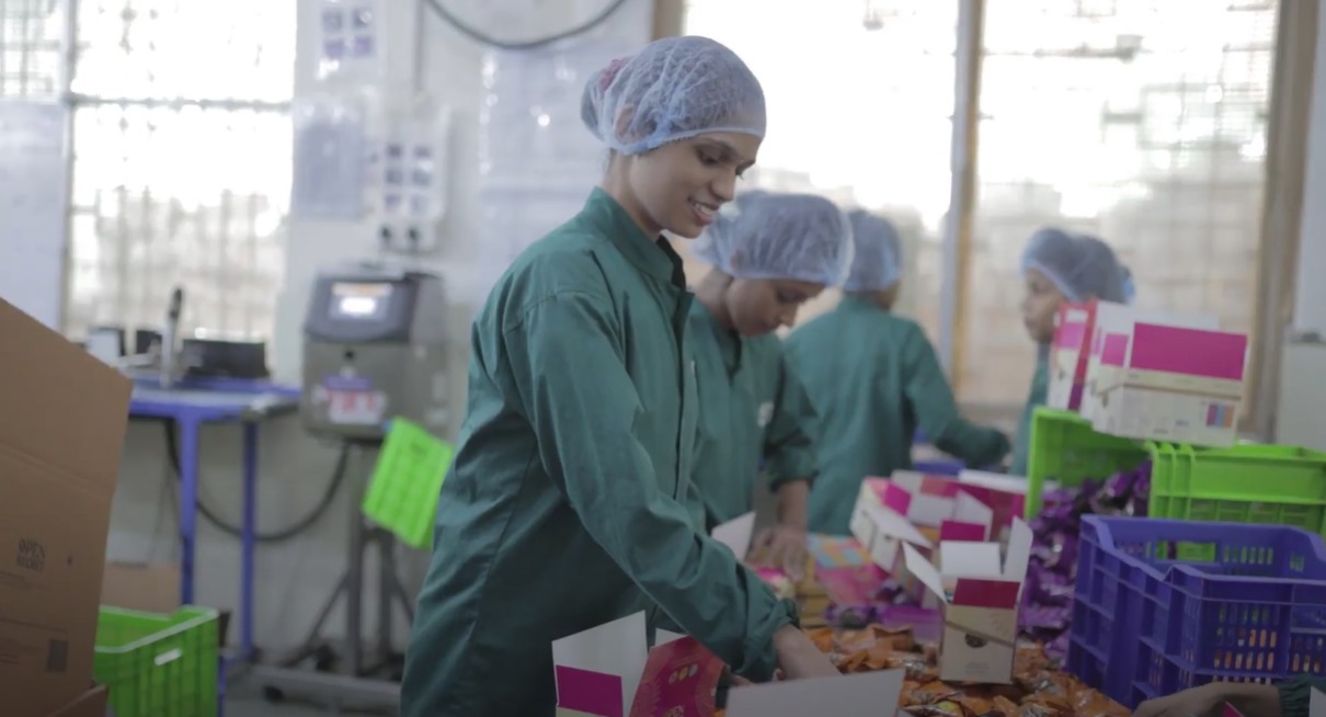 Women packing Open Secret products at their factory