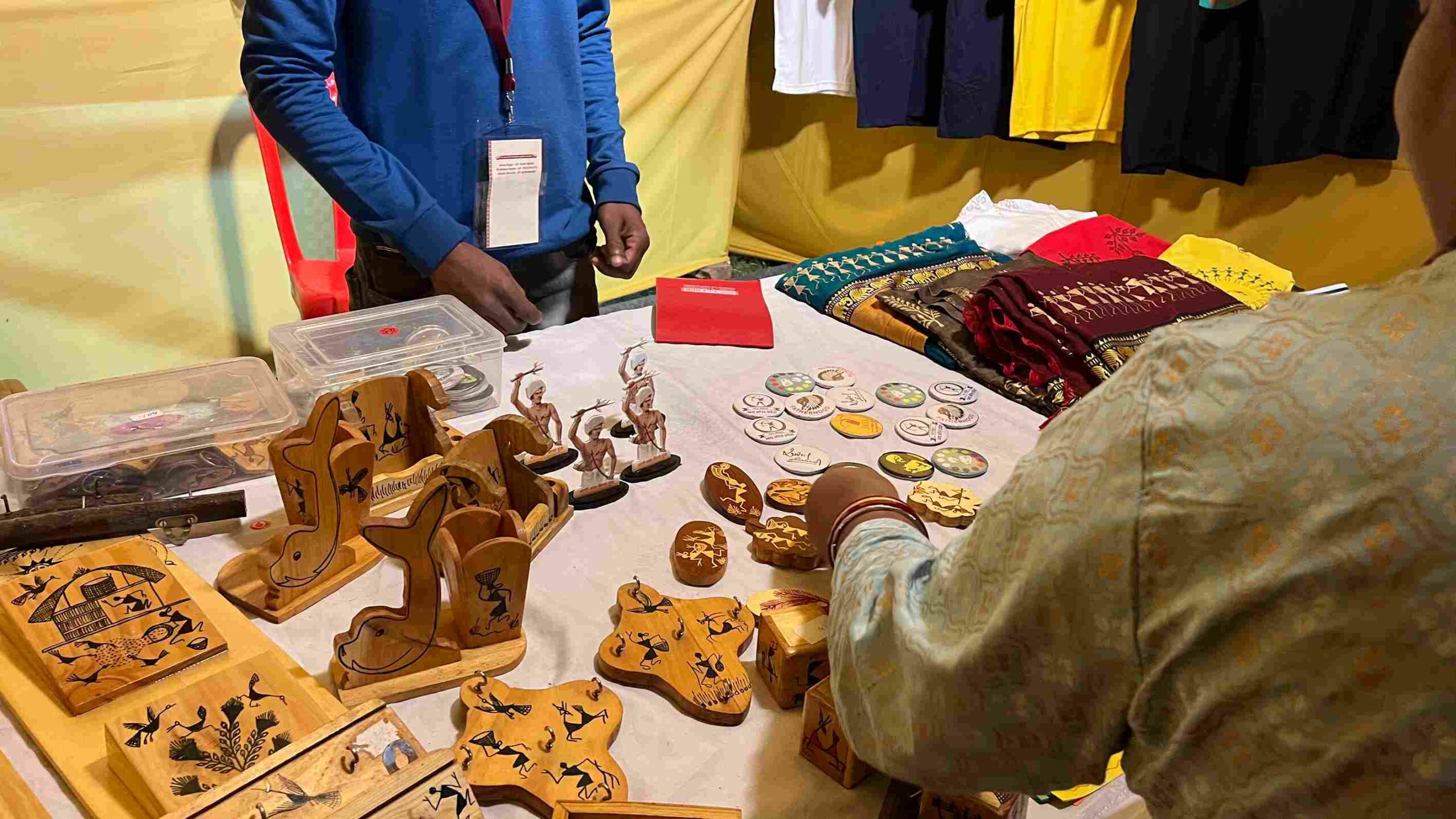A stall displaying products featuring Warli art.