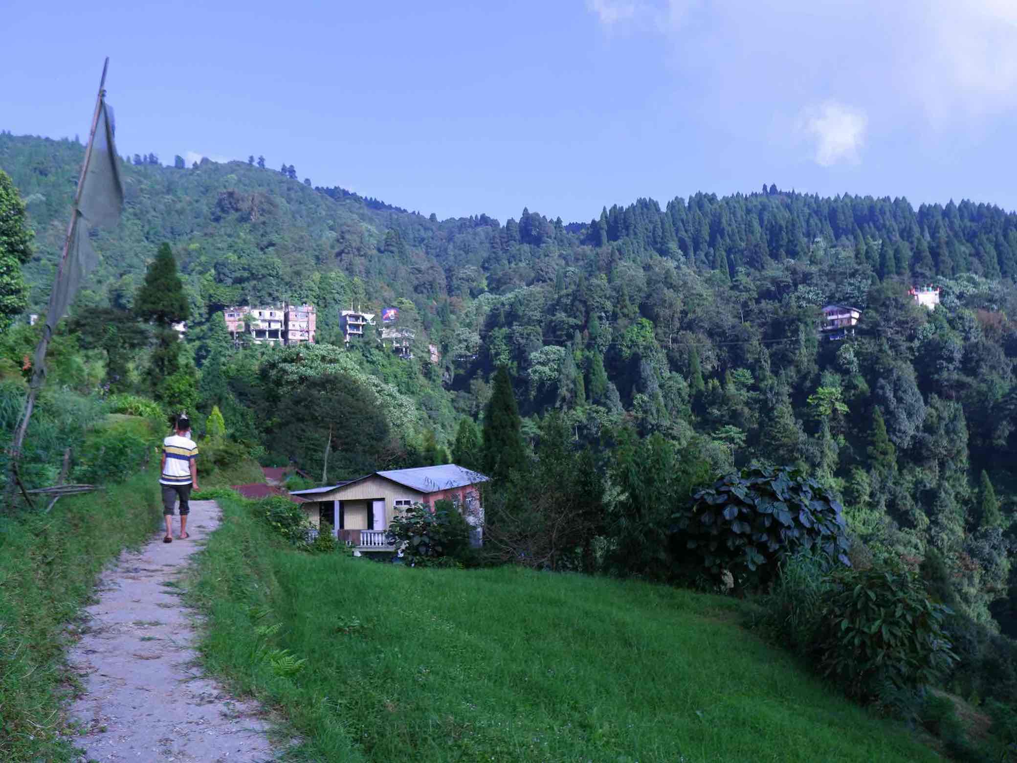 A man walks down a path in Naya Basti, near Gorabari, Darjeeling, a village that has adopted a zero-waste approach to tackle plastic pollution.