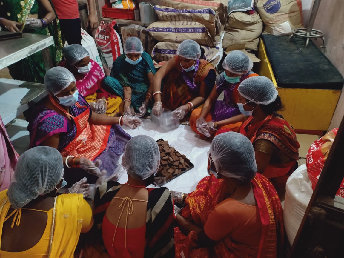 Women making millet cookies