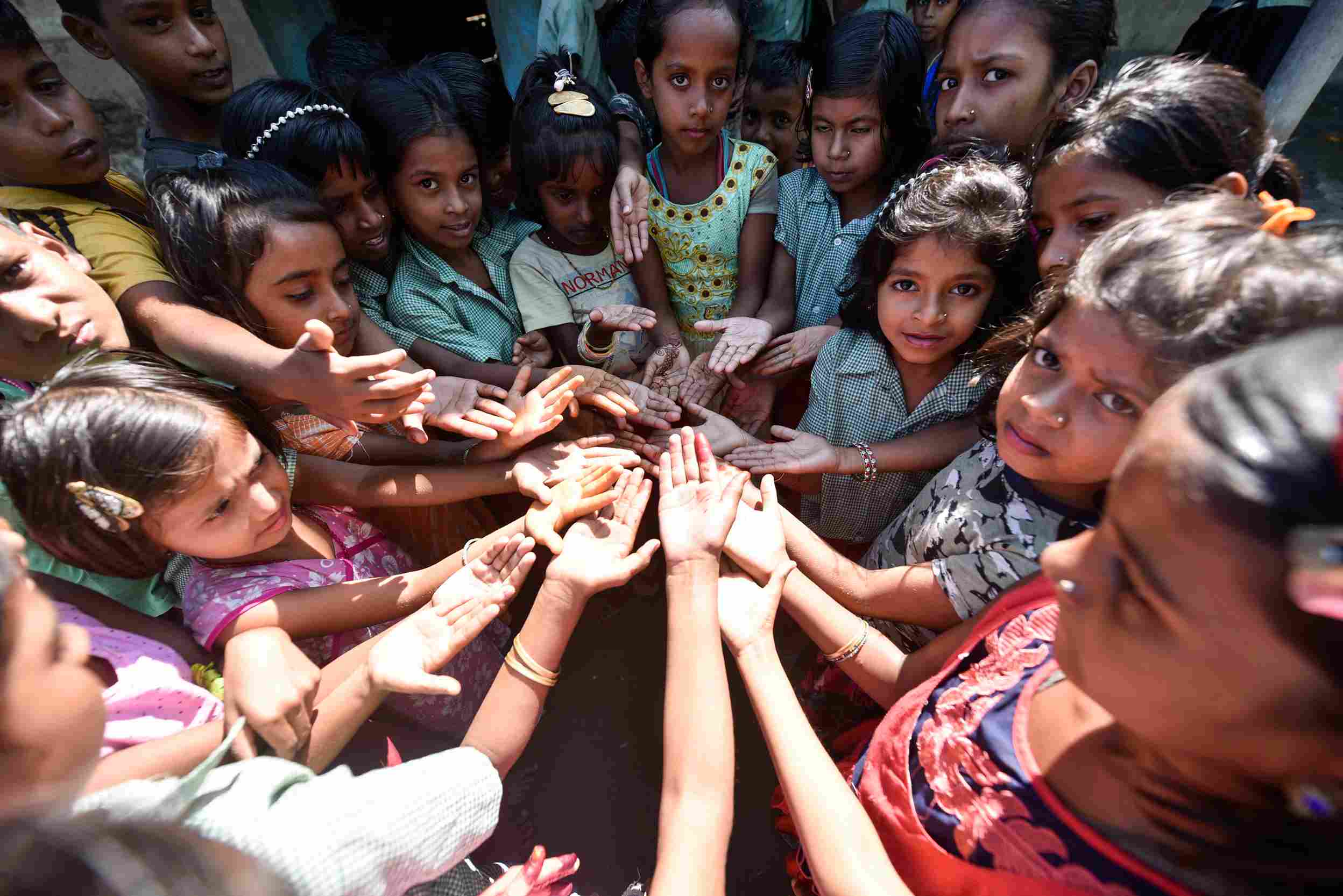 Underprivileged kids showing their clean hands