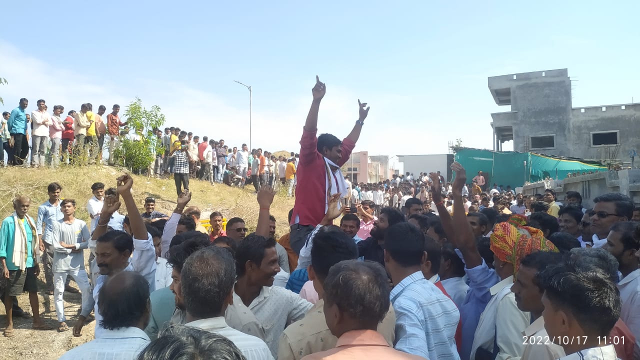 Community members joyfully lifting up an Aadiwasi Janjagruti team member in celebration after their election day victory.