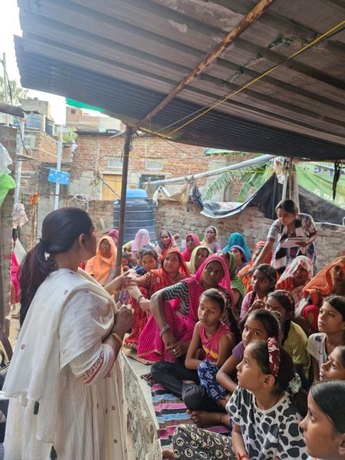 Preeti Sharma, founder of Prazna Foundation, speaking to a group of slum women, educating them about menstrual health, hygiene, and breaking the stigma surrounding menstruation.