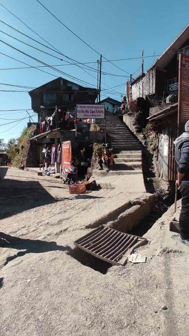 A narrow drain defines the International border in the town of Mane Bhanjyang