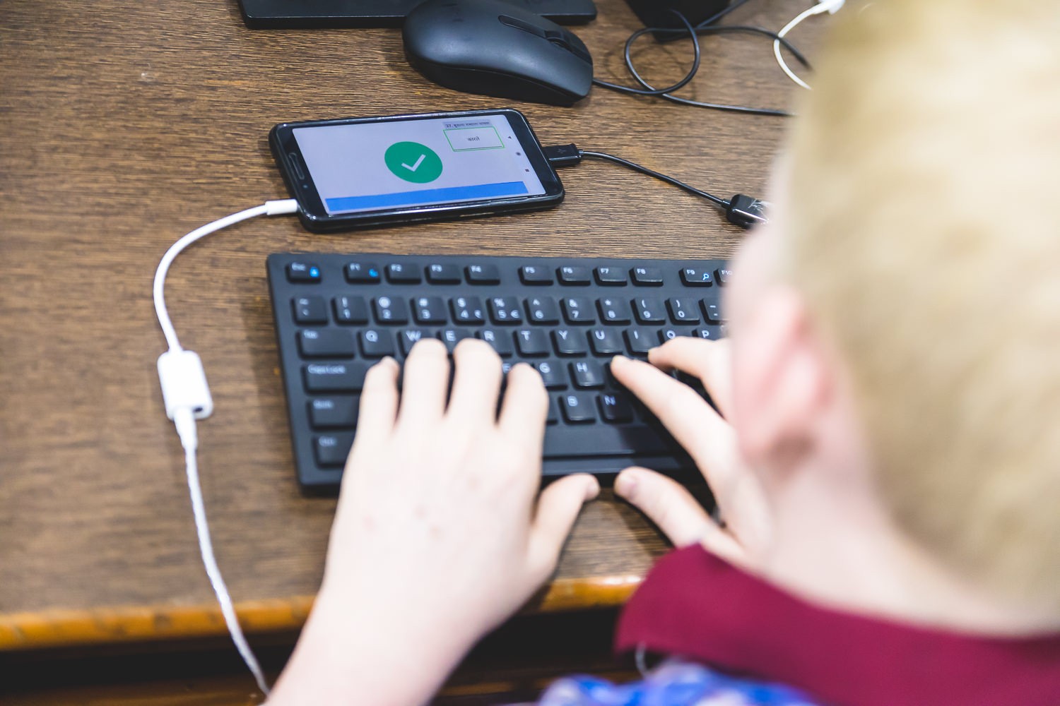 A student using the app to type in Marathi independently without a scribe.