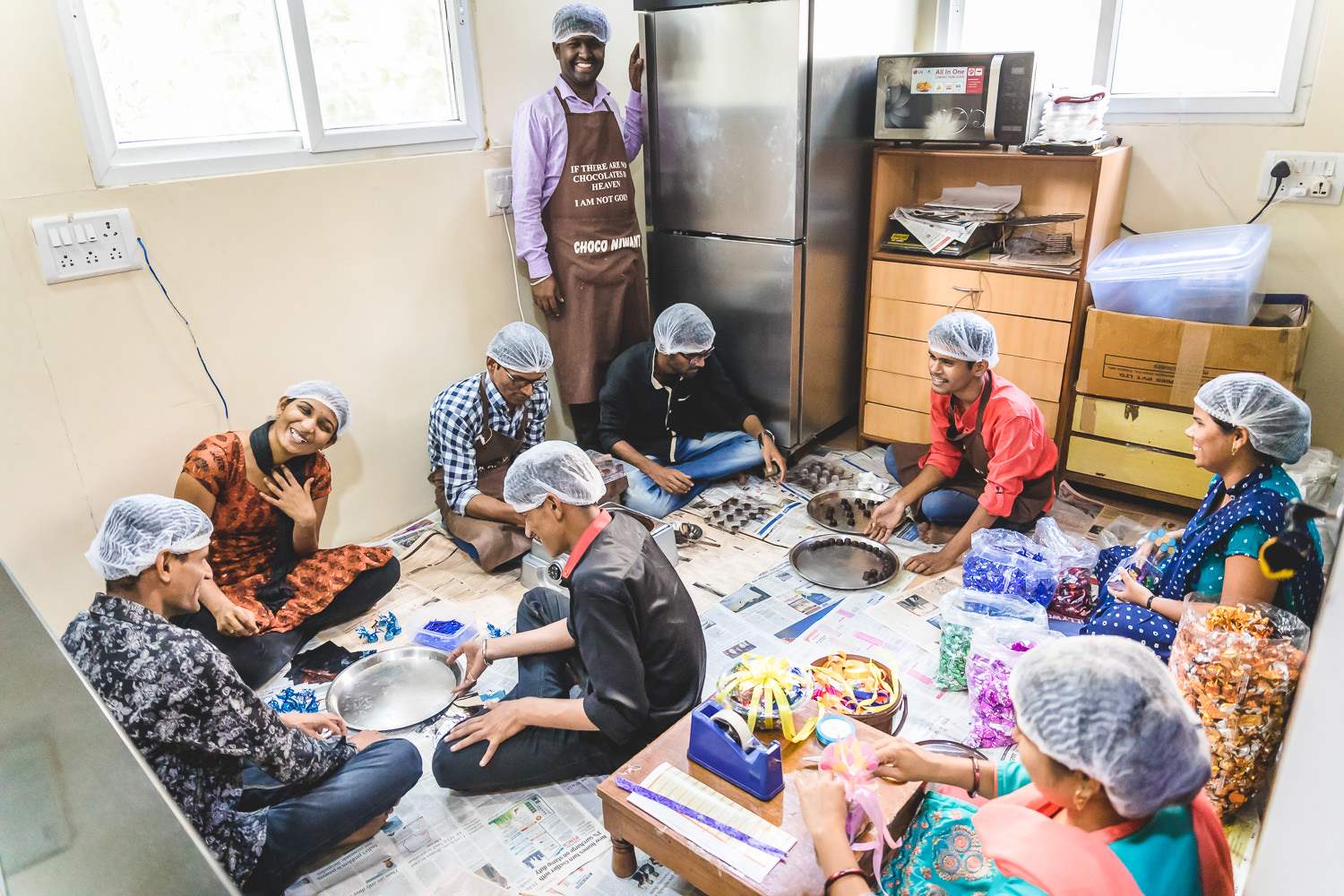 Visually impaired students at Niwant learning chocolate making skills in the kitchen.