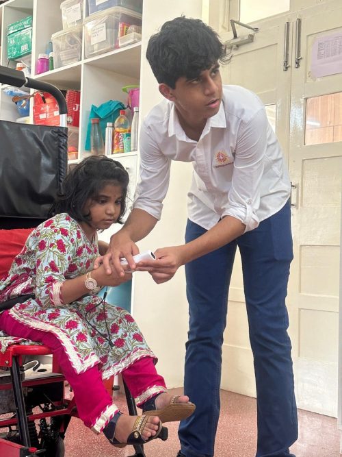 Sidhhant helping a child with a game