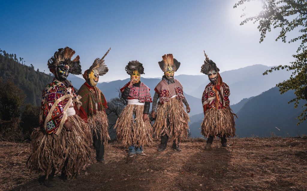 Masked men participating in Fagli celebrations, dressing up in masks to ward off evil and bring good fortune to the community.