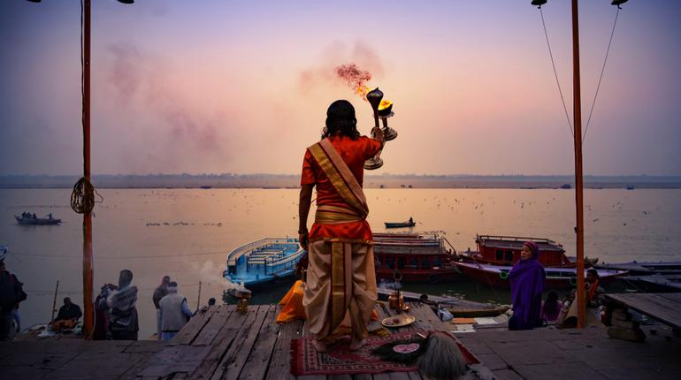 A pandit offering evening prayers on the banks of river Ganges