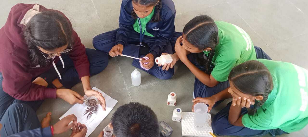 Students use the soil testing kit after learning about soil health