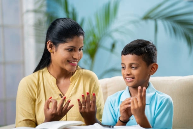 A woman helping a boy to do his homework.