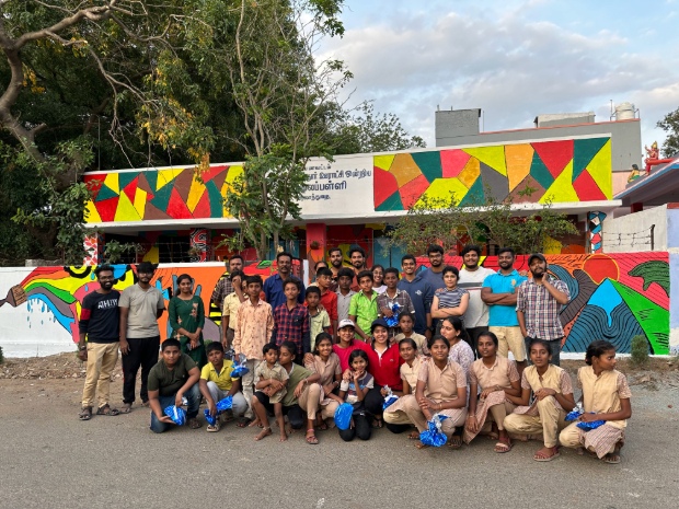 ASKK team along with the students in front of the renovated school