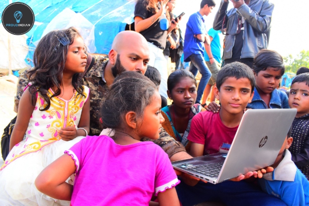 Sarjun teaching the kids with his laptop.