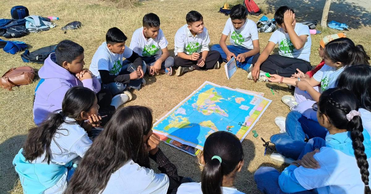 Nanakmatta students discussing the world map