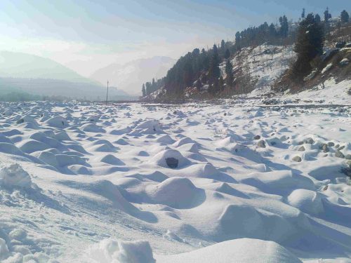 The snow-covered expanse of Hirpora looks serene but hides harsh challenges. Amid this, Ulfata Bano braves deep snow daily to keep her village connected.