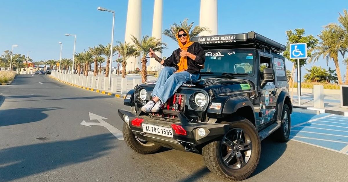 Naaji sitting on her car