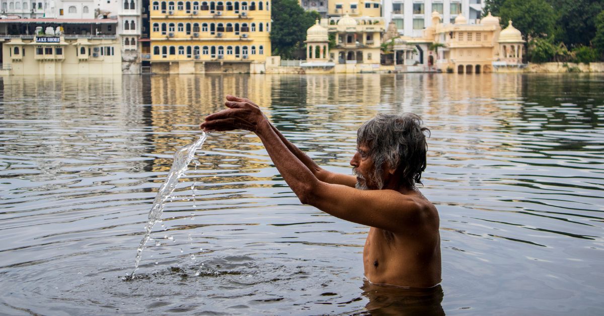 An elderly priest’s sunrise dip reflects Udaipur’s enduring spiritual bond with its lakes. 