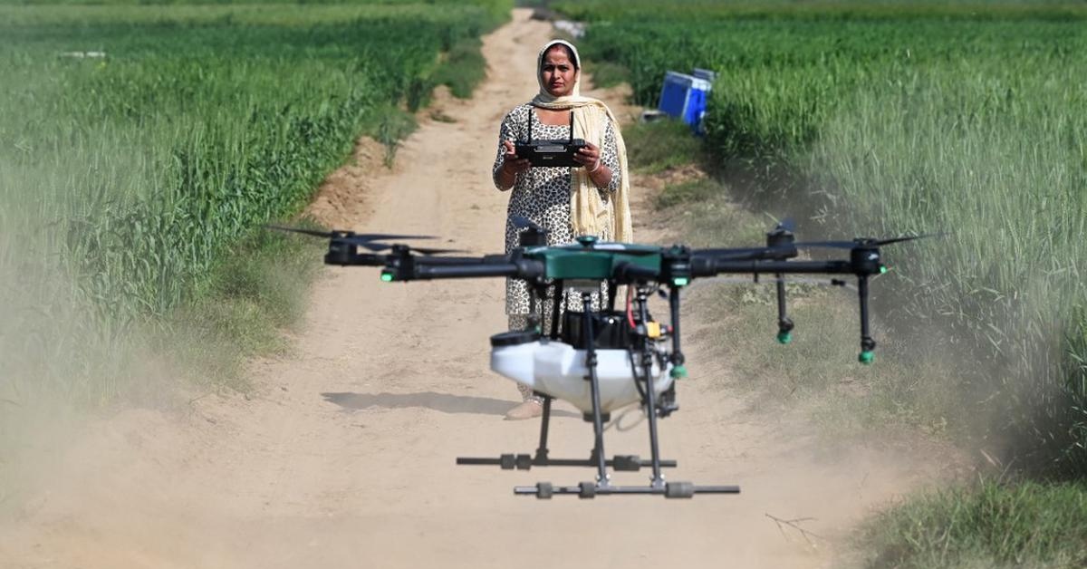 A single drone can spray 1 acre in just 7 minutes, drastically reducing labour time and chemical exposure for farmers. Picture source: AFP