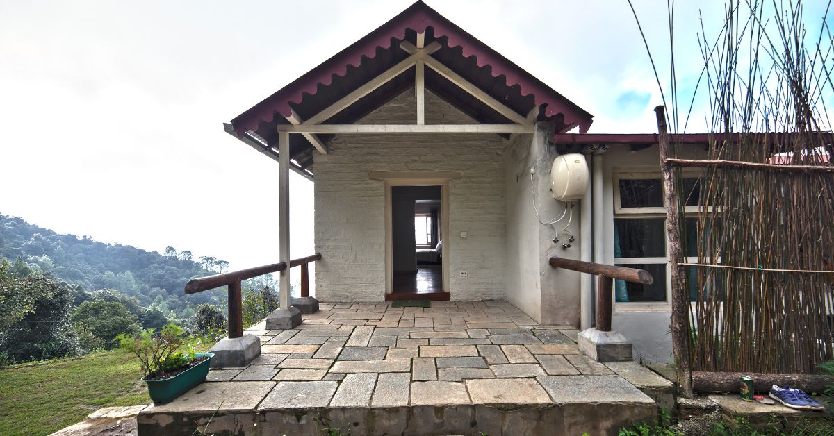 Kafal room features sheesham (Indian rosewood) flooring, white plaster walls, and handloom curtains